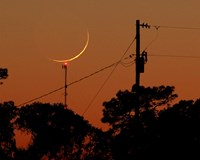 Hovering Waxing Crescent Moon (click to enlarge)